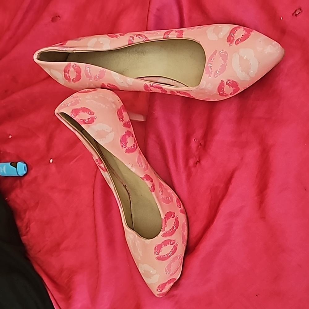 Slightly worn heels with kisses on them.